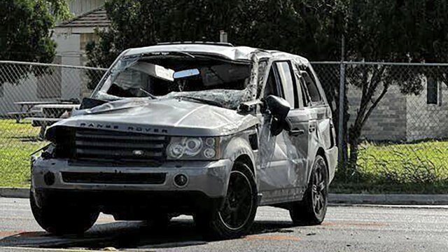 A damaged vehicle sits at the site of a deadly collision near a bus stop in Brownsville, Texas.
