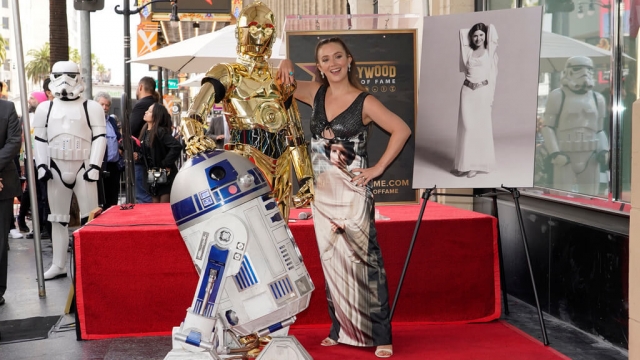 Billie Lourd poses with C3PO and R2D2 on Hollywood Walk of Fame