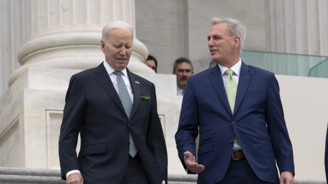 President Joe Biden walks with House Speaker Kevin McCarthy as he departs the Capitol.