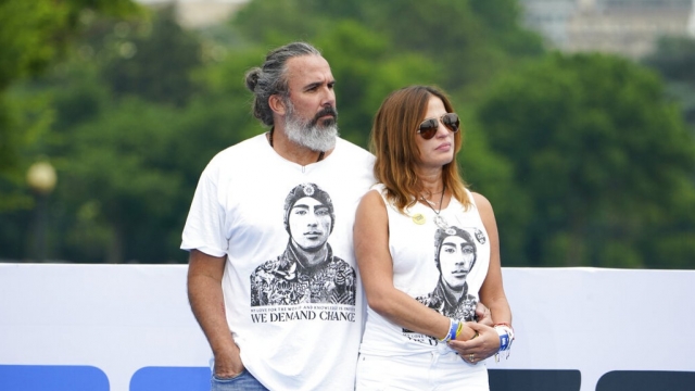 Manuel and Patricia Oliver, parents of Parkland victim Joaquin Oliver, stand by each other.