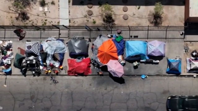Drone footage of tents along a Phoenix sidewalk.
