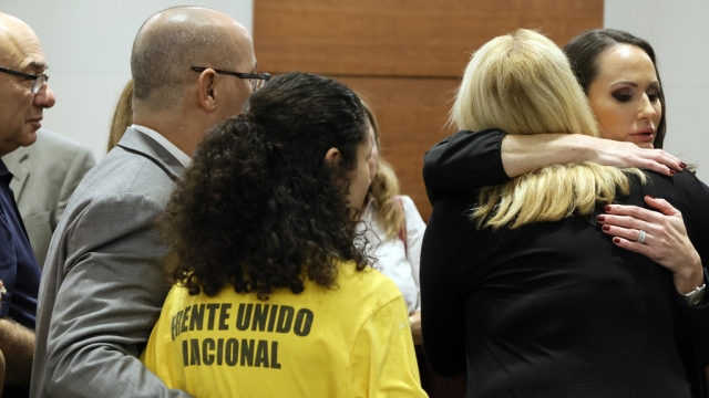 Judge Elizabeth Scherer hugs Jennifer Guttenberg after hearing for Parkland school shooter Nikolas Cruz.