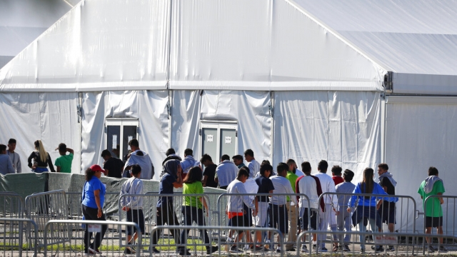 Children line up to enter a tent at the Homestead Temporary Shelter for Unaccompanied Children in Homestead, Fla.