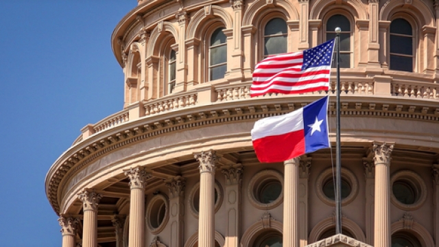 The American flag and Texas state flag on the dome of the Texas Capitol building.