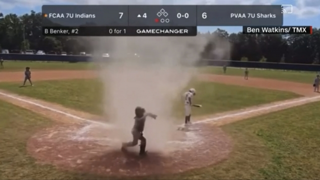 Sand and debris whirled around a 7-year-old during a baseball game.