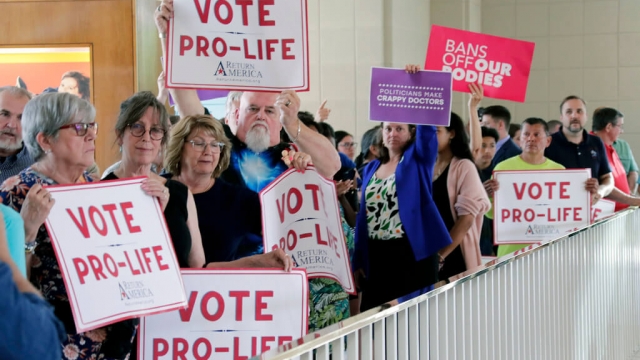 Protestors on both side of the abortion rights issue hold signs in Raleigh, North Carolina