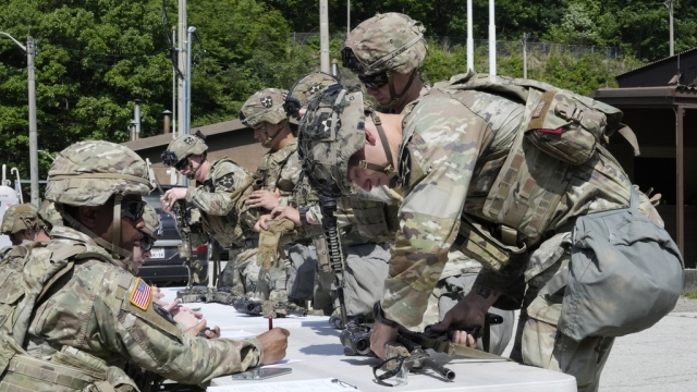 U.S. soldiers check their machine guns.