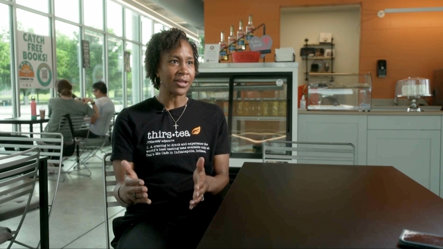 Former WNBA player Tamika Catchings talks in her tea shop, Teas Me Cafe.