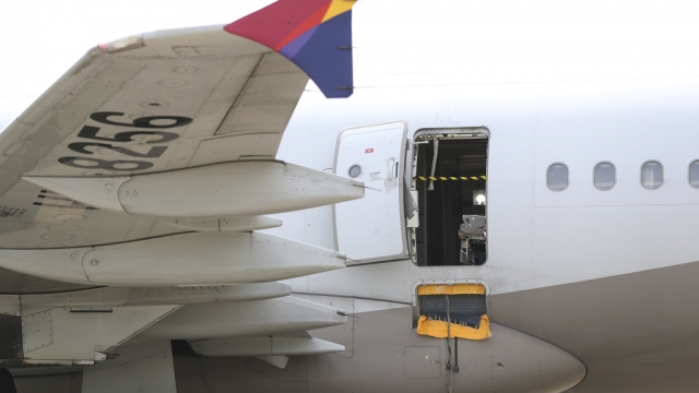 An Asiana Airlines plane is parked.