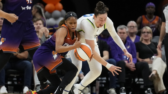 Two WNBA players playing basketball