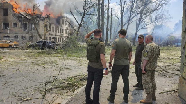 Ukraine forces watch an attack on a Ukrainian complex.