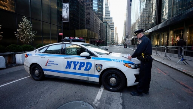 An NYPD officer blocking a street.