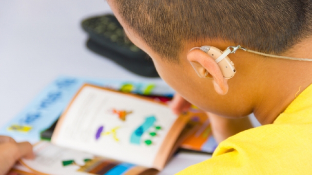 Child with a hearing aid.