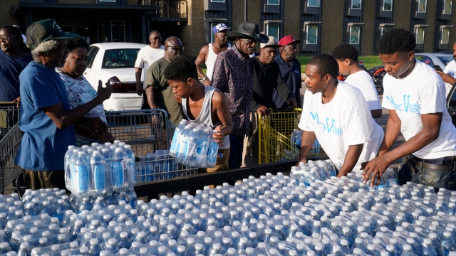 Residents in Jackson, Mississippi take delivery of bottled water