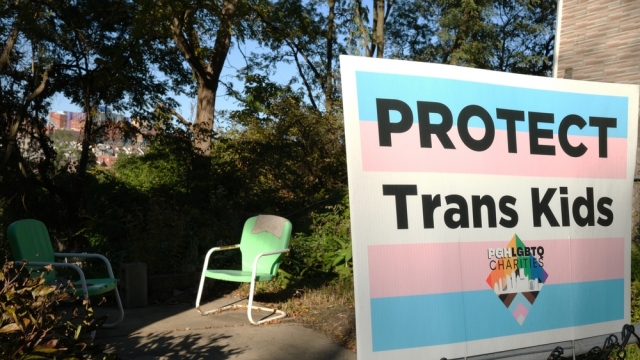 Sign reads "PROTECT Trans Kids"