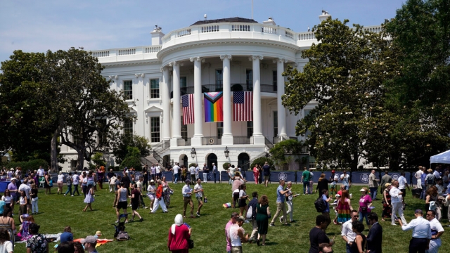 People walk on the South Lawn of the White House for Pride celebrations.