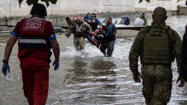 Emergency teams help rush to safety injured civilian evacuees who had came under fire from Russian forces.