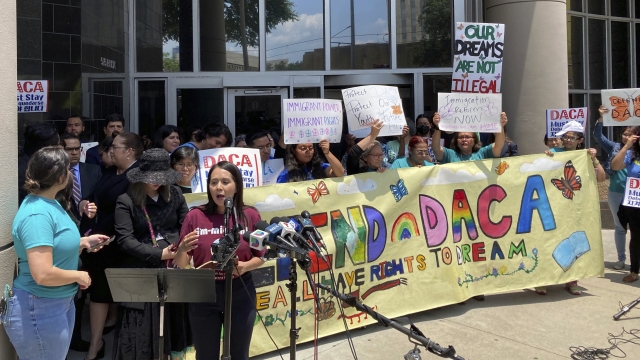 A rally outside a federal courthouse with DACA signs