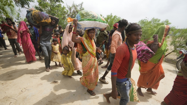 Indian residents evacuate a village as a powerful cyclone approaches.