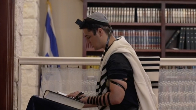 Person in a synagogue praying