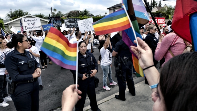 LGBTQ counter-protesters waving pride flags