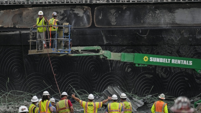 Crews work at the site of a collapse section of Interstate 95.
