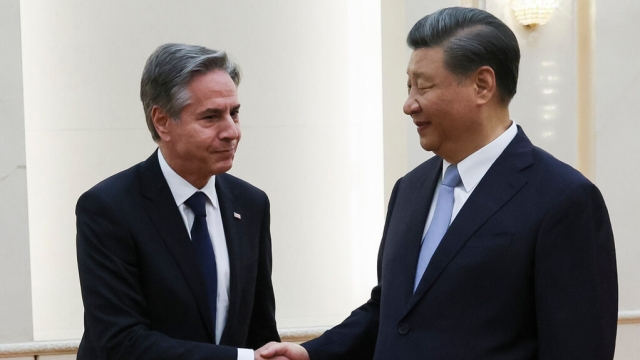 U.S. Secretary of State Antony Blinken shakes hands with Chinese President Xi Jinping.
