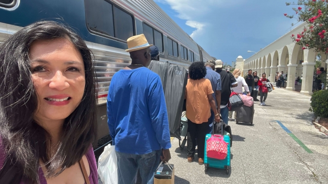 Scripps News reporter Mary Chao boards a train.