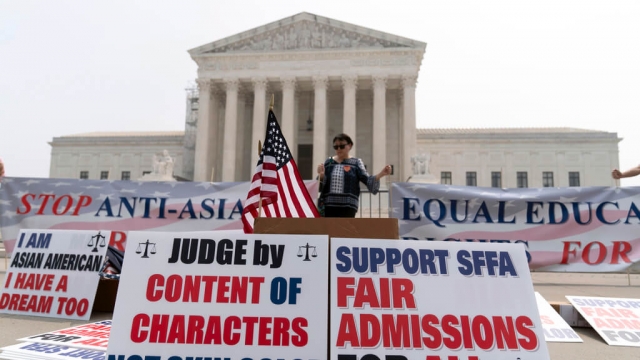 A person protests outside of the Supreme Court.