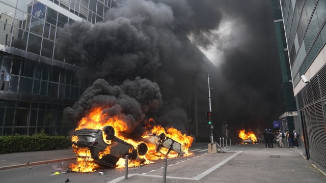 Cars burn after violent protests in France.