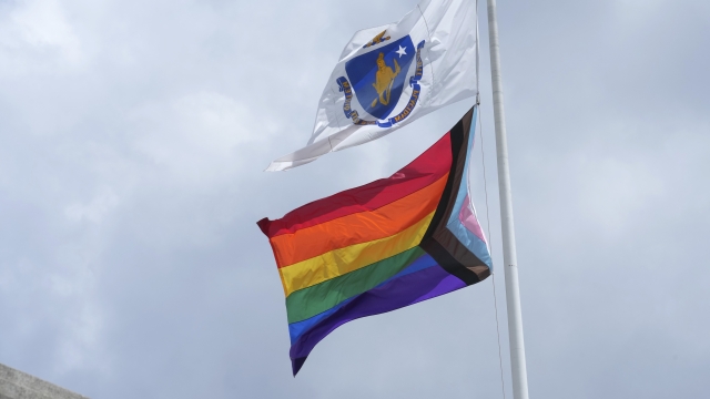 Massachusetts state flag above the LGBTQ+ flag