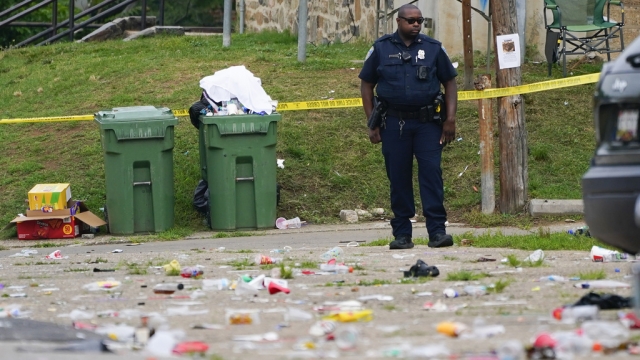 A police officer stands in the area of a mass shooting incident in Baltimore, Maryland.