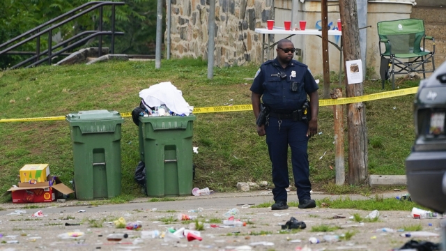 A police officer at the scene of a shooting in Baltimore