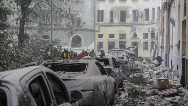 Damaged residential buildings and cars in Lviv, Ukraine, following a Russian missile attack.