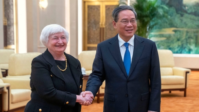 Chinese Premier Li Qiang, right, shakes hands with Treasury Secretary Janet Yellen.