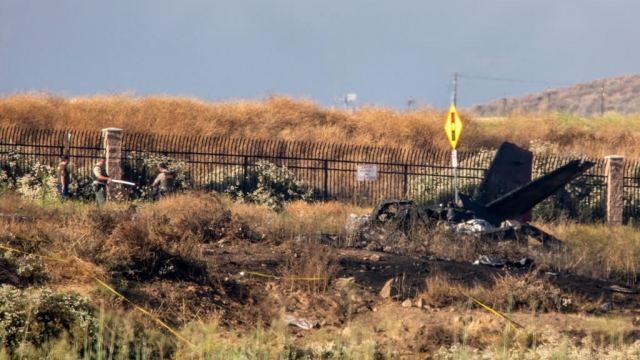 Charred remains of a Cessna lie near the landing approach at French Valley Airport.