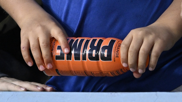 A child holds a PRIME hydration drink