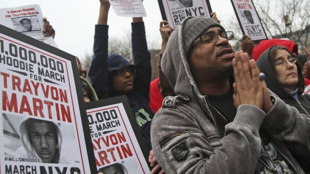 Demonstrators pray during a march for Trayvon Martin.
