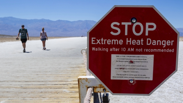 Sign warning people who are visiting Death Valley of extreme heat temperatures