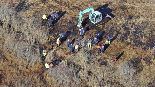 Investigators use a backhoe to dig while searching for Shannan Gilbert's body