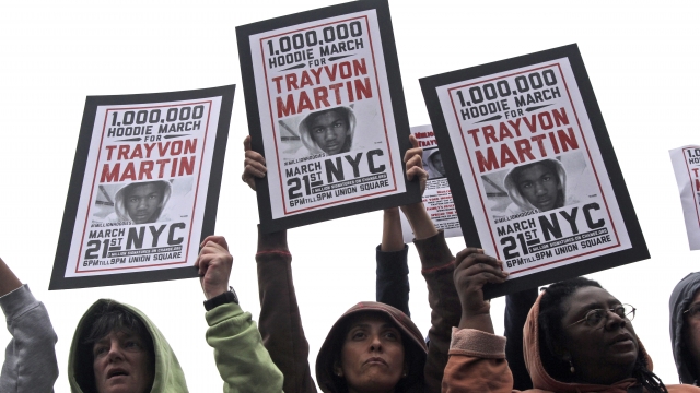 Protesters holding up posters of Trayvon Martin