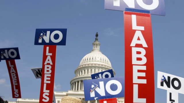 People with the group No Labels hold signs during a rally on Capitol Hill in Washington.