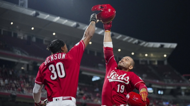 Cincinnati Reds' Joey Votto, right, celebrates with Will Benson after hitting a two-run home run.