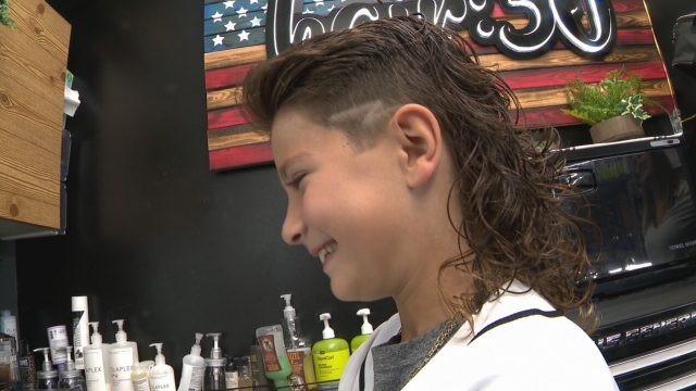Eight-year-old Owen Escoto shows off his fresh haircut.