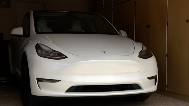 White Tesla sits in a garage