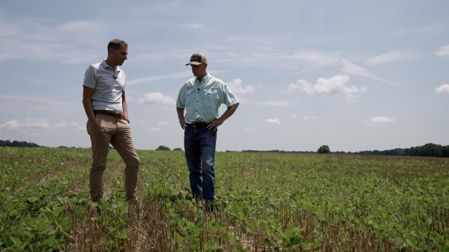 Scripps News Correspondent Chris Conte, left, stands next to farmer Jason Head.