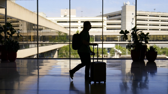 A traveler moves through the Philadelphia International Airport.