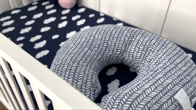 A u-shaped pillow in an infant's crib.