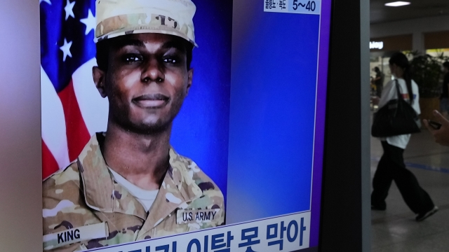 A TV screen shows a file image of American soldier Travis King.