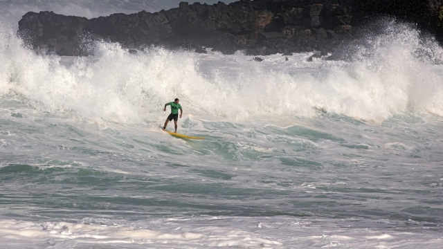 Surfing riding waves in Hawaii
